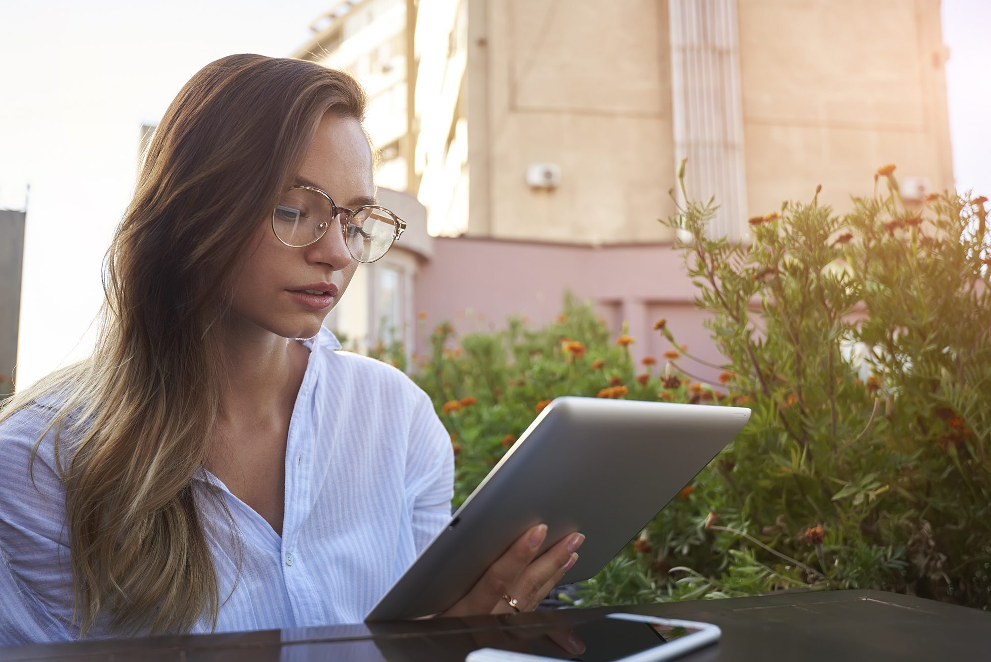 Woman reading on her tablet device